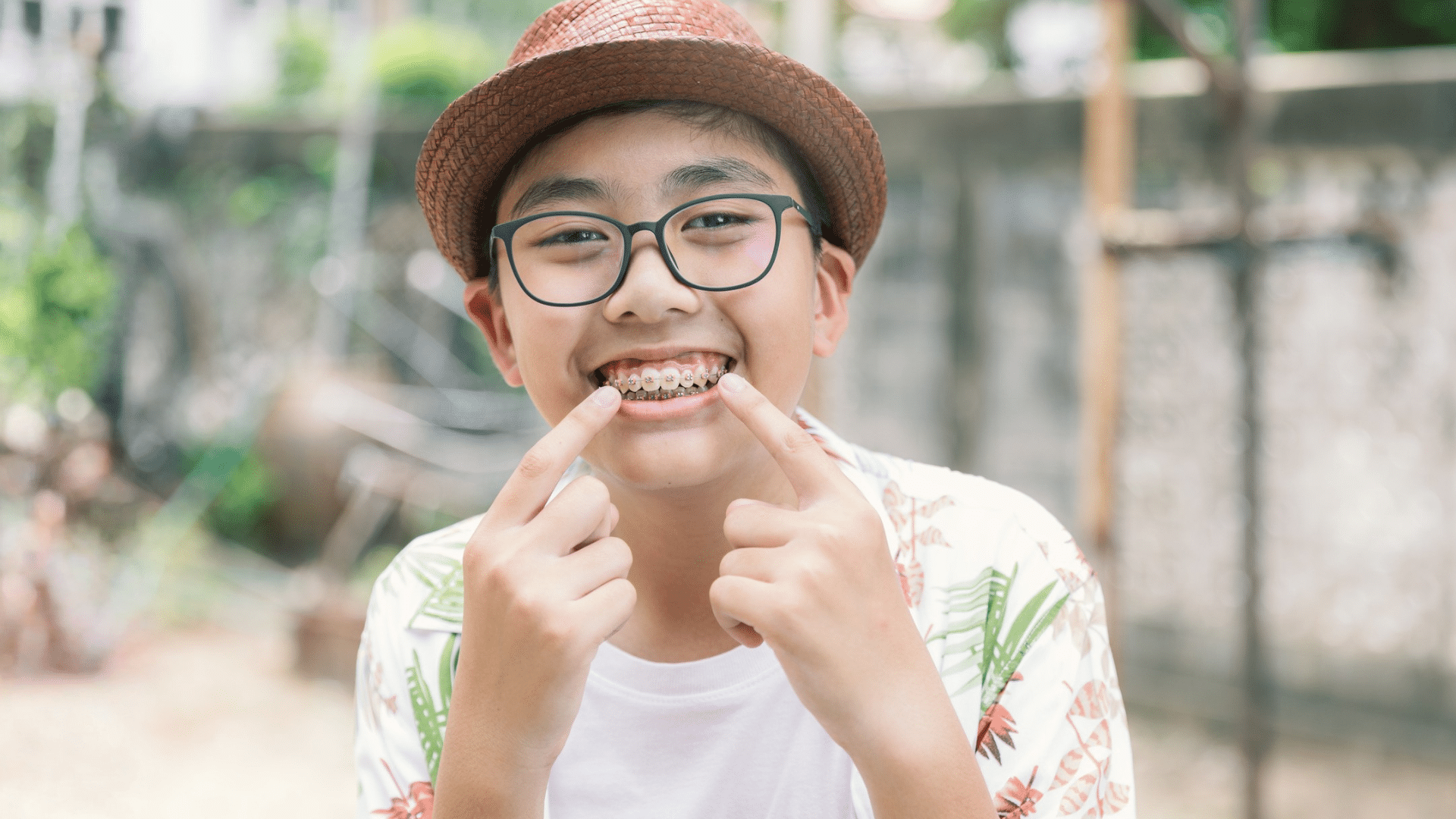 Smiling teen showing braces for teen orthodontic treatment at Bernhardt & Smith Orthodontics, Bishop Drive Office and 50th Street Office in West Des Moines, IA