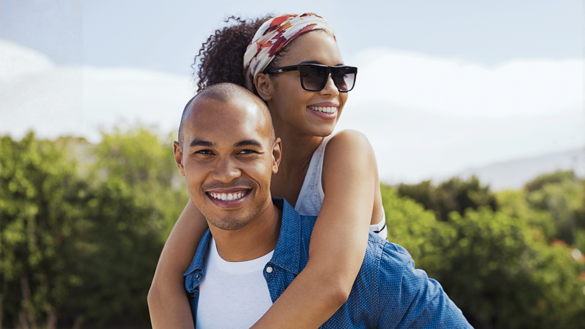 Smiling adult couple outdoors for adult orthodontic care at Bernhardt & Smith Orthodontics, Bishop Drive Office and 50th Street Office in West Des Moines, IA