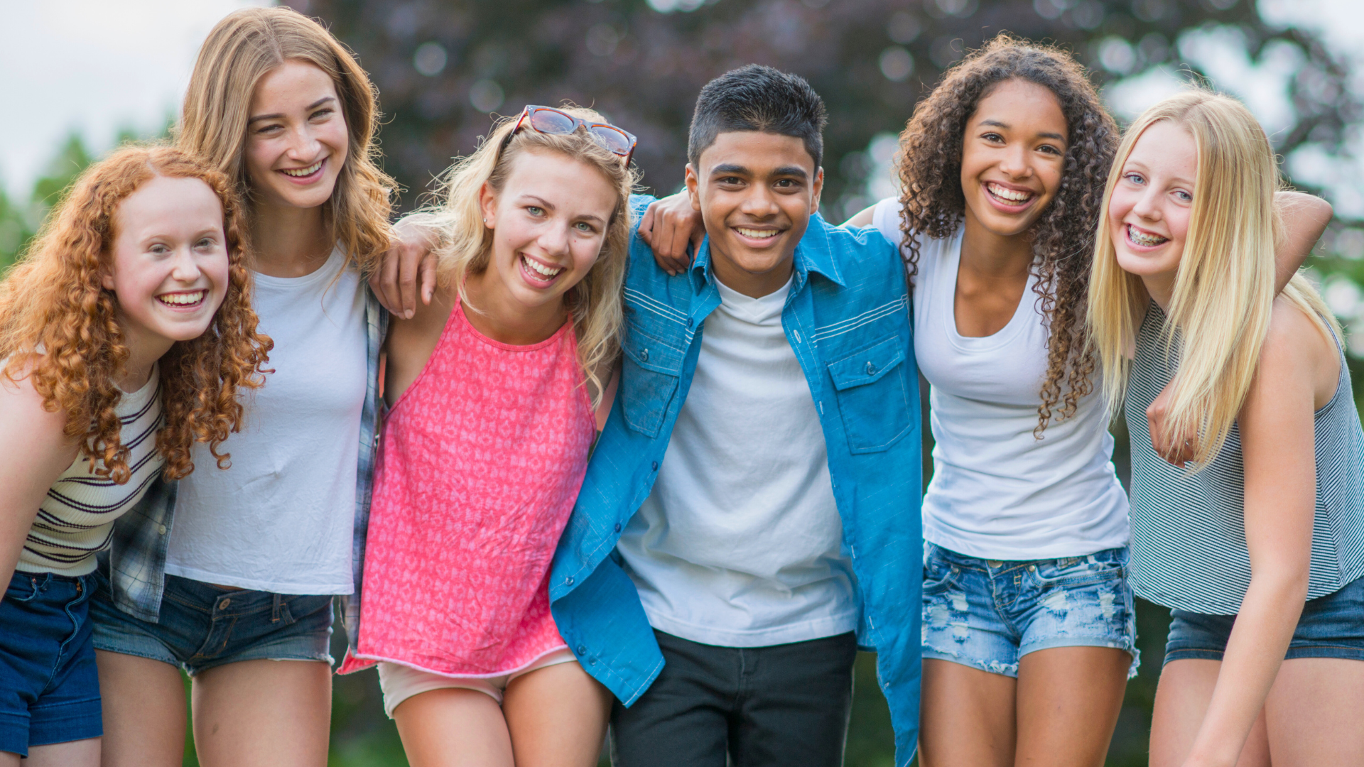 Group of smiling teen friends outdoors for orthodontic care at Bernhardt & Smith Orthodontics, Bishop Drive Office and 50th Street Office in West Des Moines, IA