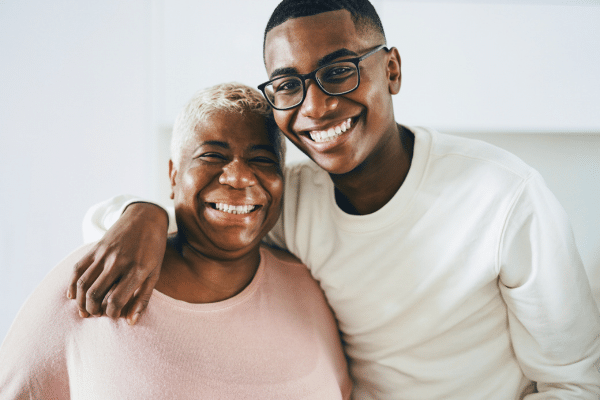 Smiling adult patient with family member for orthodontic financing and insurance options at Bernhardt & Smith Orthodontics, Bishop Drive Office and 50th Street Office in West Des Moines, IA