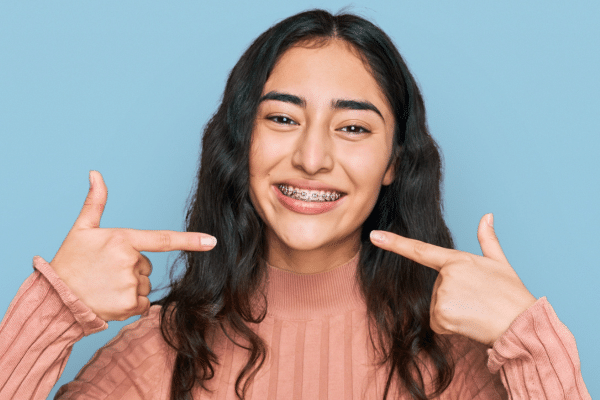 Smiling teen wearing braces for teen orthodontic treatment at Bernhardt & Smith Orthodontics, Bishop Drive Office and 50th Street Office in West Des Moines, IA