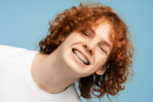 Smiling patient wearing braces for surgical orthodontic treatment at Bernhardt & Smith Orthodontics, Bishop Drive Office and 50th Street Office in West Des Moines, IA