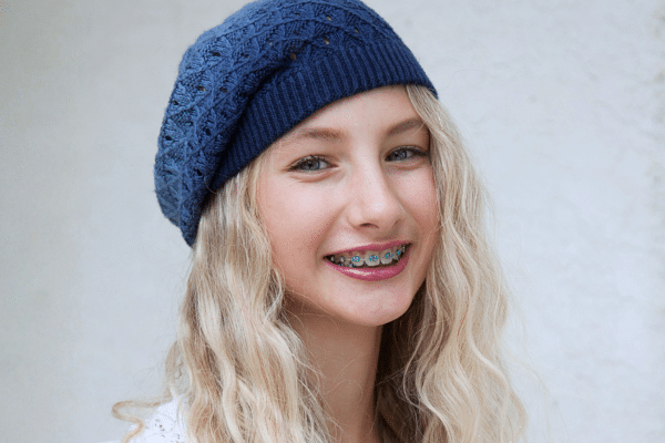 Smiling young patient wearing braces for surgical orthodontic treatment at Bernhardt & Smith Orthodontics, Bishop Drive Office and 50th Street Office in West Des Moines, IA
